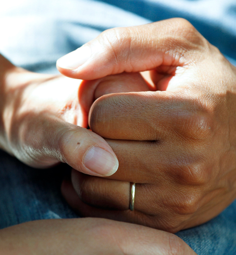 Critical Incident with two people holding hands in a supportive manner